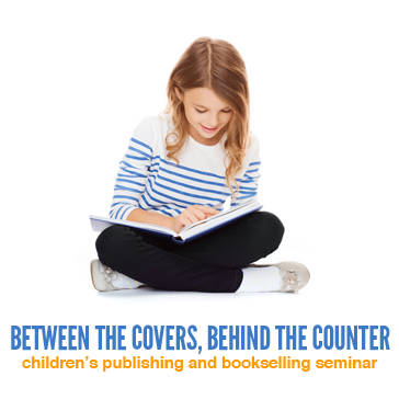 A photograph of a young girl sitting an reading a book, text underneath reads 'Between the Covers, Behind the Counter, Children's Publishing and Bookselling Seminar.'